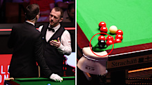 Mark Allen of Northern Ireland speaks with referee, Marcel Eckardt amid a stalemate in his world championship semi-final against Yize Wu.