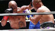 Mike Tyson throws a punch at Roy Jones Jr during their fight.