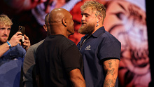 Mike Tyson shapes up to Jake Paul at a press conference.