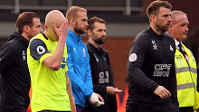 Aaron Mooy (L) holds his hand to his face after Huddersfield's EPL relegation.