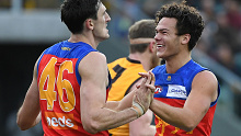 Lions youngster Cam Rayner celebrates a goal with Oscar McInerney