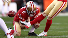 Australian punter Mitch Wishnowsky makes a hold for a kick against the Vikings.