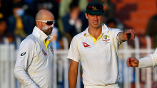 Nathan Lyon (left) chatting with Pat Cummins during the first men's Test between Australia and Pakistan.