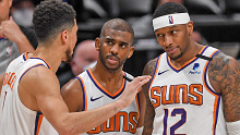 Chris Paul (3) and Torrey Craig (12) listen to Devin Booker (1) of the Phoenix Suns 