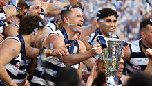 Geelong captain Joel Selwood lifts the premiership cup after his final AFL game, the 2022 grand final