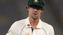 Travis Head of Australia is seen wearing low light glasses while fielding