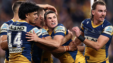 Mitchell Moses (C) celebrates an Eels try against the Roosters.