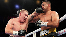 Paul Gallen lands a left on Justin Hodges' head during their heavyweight clash in Sydney.