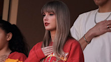 Taylor Swift pauses for the national anthem alongside Brittany Mahomes, right, before the start of an NFL football game between the Kansas City Chiefs and the Los Angeles Chargers Sunday, Oct. 22, 2023, in Kansas City, Mo. (AP Photo/Charlie Riedel)