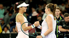 Ajla Tomljanovic and Jelena Ostapenko half-embrace at the net following their second round clash at the Australian Open.