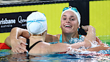 Kaylee McKeown and Mollie O'Callaghan embrace after the women's 100m backstroke final.