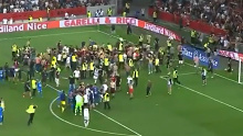 Fans invade the pitch as the match between Nice and Marseille is halted.