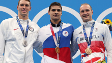 Silver medallist Ryan Murphy of Team United States, gold medallist Evgeny Rylov of Team ROC and bronze medallist Luke Greenbank of Team Great Britain pose on the podium during the medal ceremony for the Men's 200m Backstroke Final at the Tokyo Olympics.