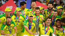 Aaron Finch and the Australian team poses with the World Cup trophy after beating New Zealand in the final
