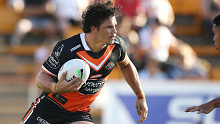 James Roberts of Wests Tigers runs the ball during a trial against Manly at Leichhardt Oval. The former NSW State of Origin centre switched clubs from South Sydney in a fresh bid to revive his career.