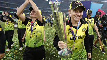 World Cup final player of the match Alyssa Healy takes the trophy on a victory lap of the MCG.
