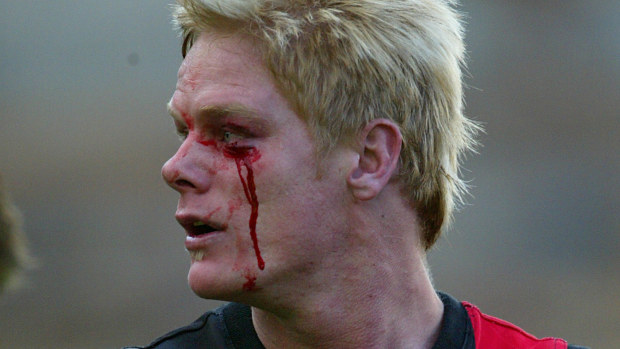 Adam McPhee leaves the field after an all-in brawl erupted during the infamous 'Line in the Sand' match in 2004 between Essendon and Hawthorn.