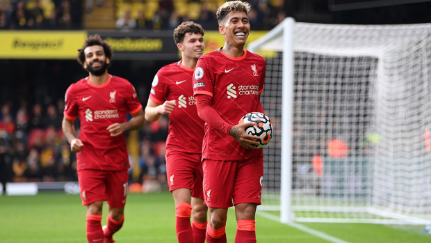 Roberto Firmino of Liverpool celebrates after scoring their team's fifth goal completing his hat-trick