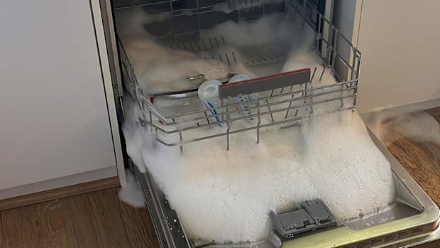 A woman's dishwasher overflowed with detergent foam after using washing up liquid in it.