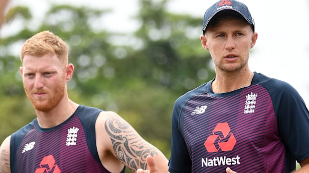 England captain Joe Root speaks to his team alongside Ben Stokes