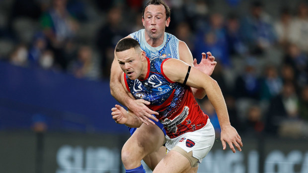 Steven May of the Demons and Todd Goldstein of the Kangaroos compete for the ball