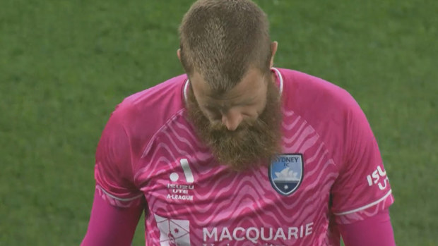 A despondent Andrew Redmayne of Sydney FC walks from the field after he was red carded for a handball in the first half against Macarthur.