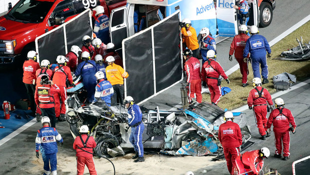 Rescue workers remove Ryan Newman from his car after he was involved in a wreck on the last lap of the NASCAR Daytona 500 