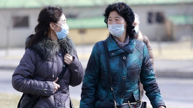 Locals in Pyongyang wearing protective masks.