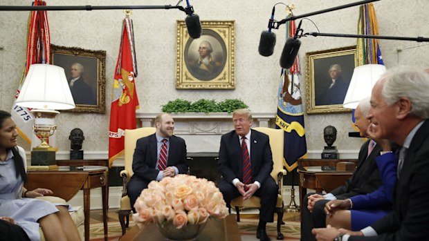 President Donald Trump, right, talks with Joshua Holt, who was recently released from a prison in Venezuela, in the Oval Office of the White House. (AAP)