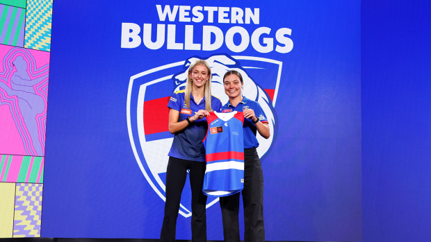 Kristie-Lee Weston-Turner is presented her jumper by Ellie Blackburn of the Bulldogs during the 2023 AFLW Draft.