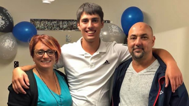 Christopher Cassaniti celebrating his 18th birthday with his parents.