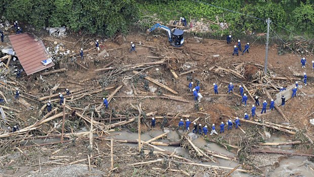 Rescue workers search for missing persons at a site of a landslide following a heavy rain in Tsunagi town, Kumamoto prefecture, southern Japan Saturday, July 4, 2020
