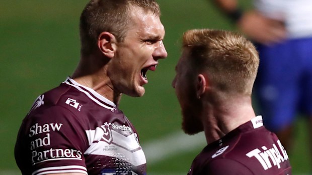 Tom Trbojevic (L) of the Sea Eagles celebrates 