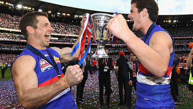 Dale Morris and Tom Boyd with the 2016 AFL premiership trophy.