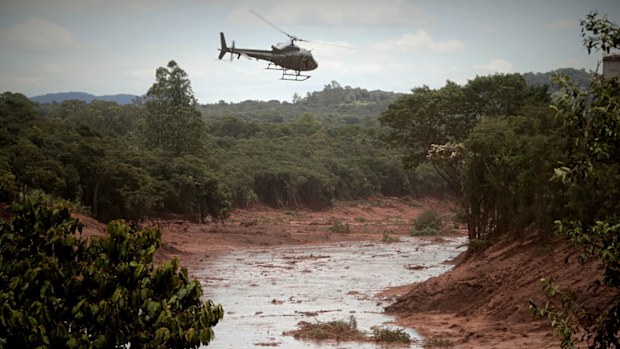 The slow speed of search efforts was due to the treacherous sea of reddish-brown mud that surged out when the mine dam breached on Friday afternoon.

