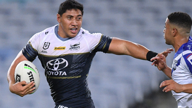Jason Taumalolo of the Cowboys fends off a tackle from Brandon Wakeham of the Bulldogs as he makes a break during the round two NRL match 