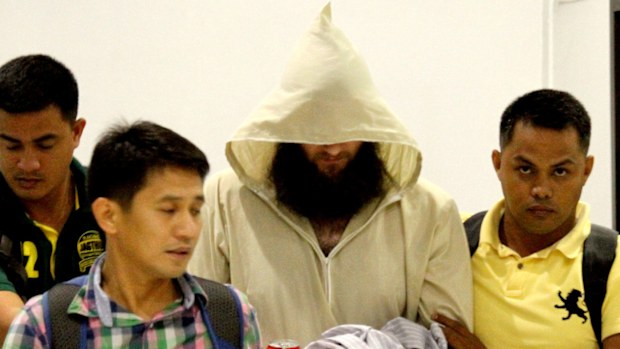 Police escort Australian Islamic preacher Robert "Musa" Cerantonio at the Ninoy Aquiono International Airport in Manila, Philippines. (AAP)