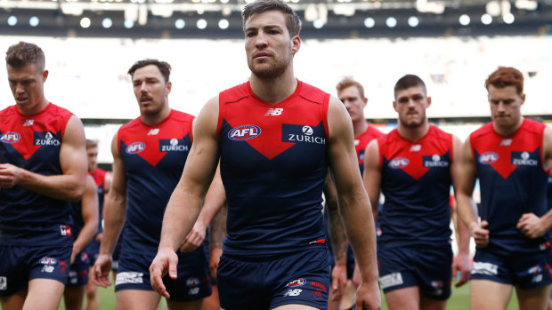 Demons players react after the Round 21 AFL match 