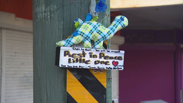 Tributes have been left on a street where a child was found dead in a hot car in Sydney.