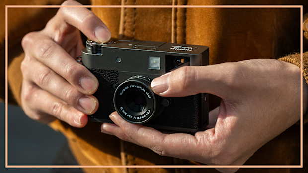 9PR: Fujifilm Half X camera held my a man.