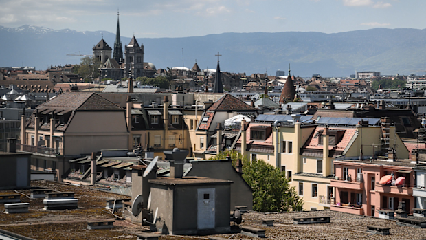 This picture taken on May 13, 2019 shows the St. Pierre Cathedral overlooking the roofs in the center of Geneva. (Photo by Fabrice COFFRINI / AFP)      