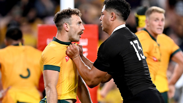Nic White of the Wallabies and Anton Lienert-Brown of the All Blacks face off
