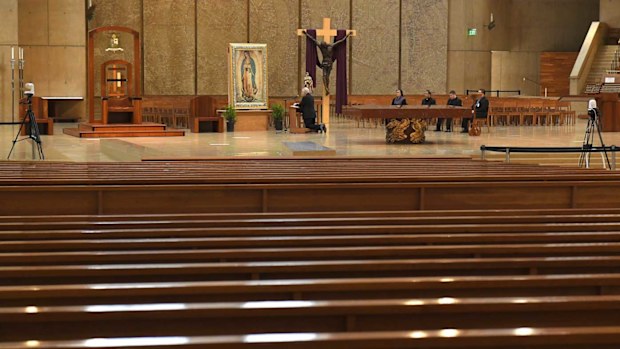 Archbishop of Los Angeles Jose H Gomez prays the rosary in front of an empty cathedral.