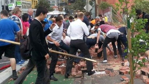 Bystanders rush in to rescue people from a collapsed wall in Melbourne in 2013. (9NEWS)