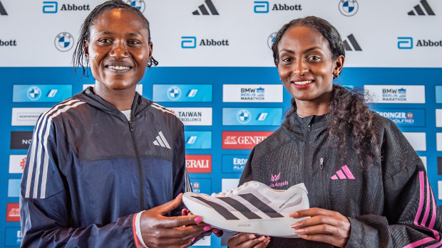 Tgist Assefa (left) displays the Adidas Adizero Adios Pro Evo 1 with Sheila Chepkiru ahead of Sunday's Berlin Marathon.