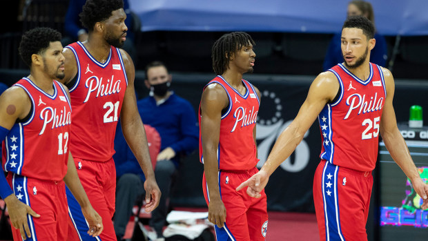 Tobias Harris #12, Joel Embiid #21, Tyrese Maxey #0 and Ben Simmons #25 of the Philadelphia 76ers walk back onto the court 