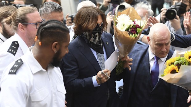Actor Johnny Depp, centre, receives flowers as he arrives at the High Court for a hearing in his libel case, in London, Friday, July 24, 2020