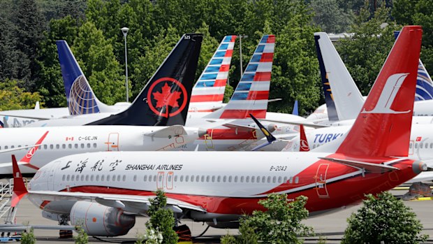 Dozens of grounded Boeing 737 MAX airplanes crowd a parking area adjacent to Boeing Field Thursday, June 27, 2019, in Seattle. A new software problem has been found in the troubled Boeing 737 Max that could push the plane's nose down automatically, and fixing the flaw is almost certain to further delay the plane's return to flying after two deadly crashes. 