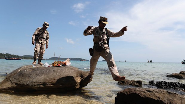 Cambodia soldiers leap rocks after offering prayers in hopes of finding British national Amelia Bambridge on the shore of Koh Rong island. 