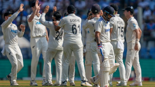 Virat Kohli walks off after being dismissed.